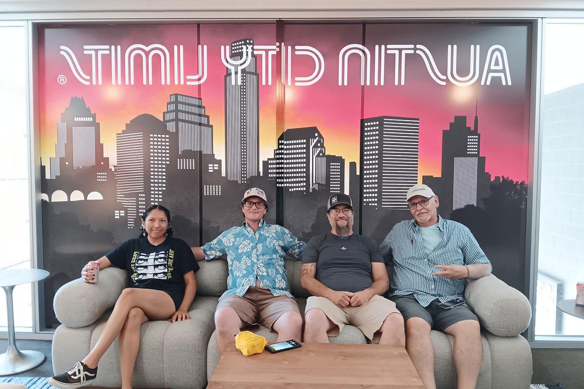 Group of TRIO Students on a couch with a Austin City Limits sign behind them.
